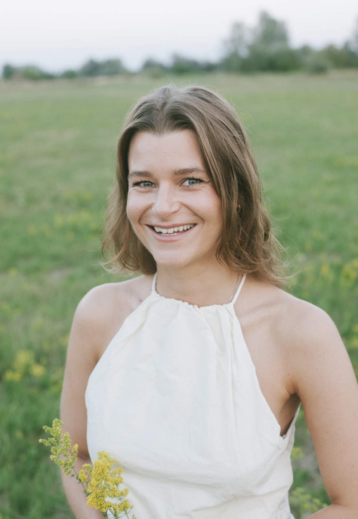 Viktória Kaslik in a field of wildflowers.