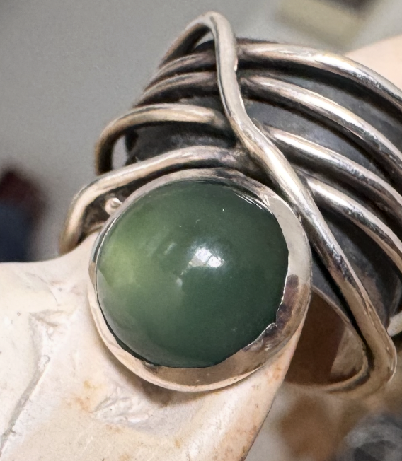 Green agate ring wrapped in silver wire.