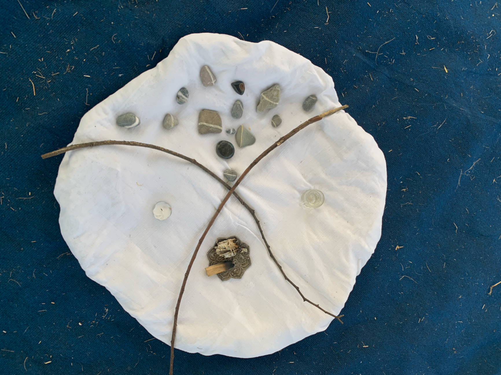 Ritual objects on white cloth.